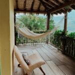 relaxing-tropical-hammock-and-chair-on-a-wooden-porch-in-medellin-colombia.-14610826-1536x2048